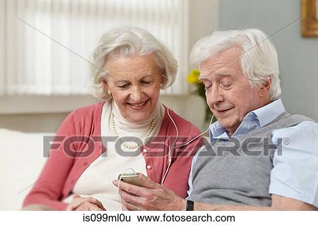 Senior couple listening to mp3 player View Large Photo Image Stock Photograph - Senior couple listening to mp3 player. Fotosearch