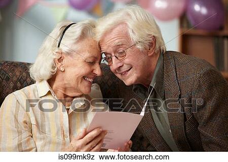 Senior couple reading birthday card View Large Photo Image Stock Photo - Senior couple reading birthday card. Fotosearch
