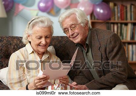 Stock Photography - Senior couple reading birthday card. Fotosearch
