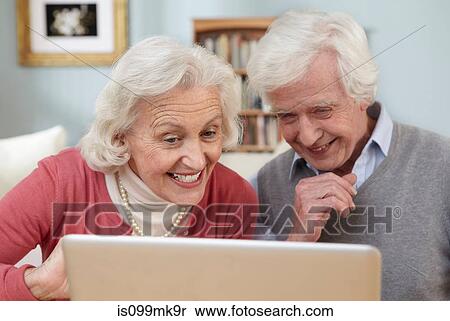 Stock Photography - Senior couple using laptop. Fotosearch
