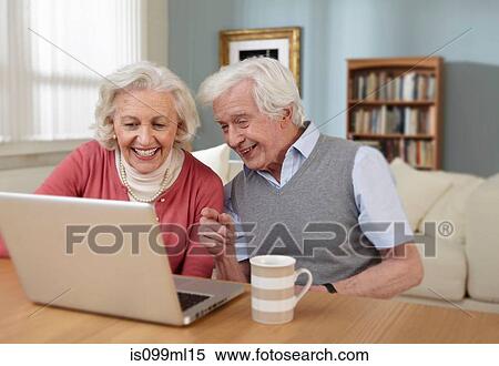 Senior couple using laptop View Large Photo Image Stock Photography - Senior couple using laptop. Fotosearch