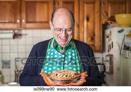 Senior man holding freshly baked pie View Large Photo Image Stock Image - Senior man holding freshly baked pie. Fotosearch