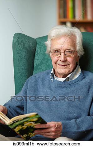 Stock Image - Senior man reading book, portrait. Fotosearch
