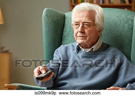 Senior man using remote control View Large Photo Image Stock Photography - Senior man using remote control. Fotosearch
