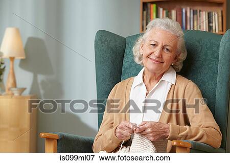 Stock Photo - Senior woman knitting, portrait. Fotosearch