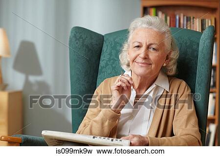 Senior woman with newspaper, portrait View Large Photo Image Stock Photo - Senior woman with newspaper, portrait. Fotosearch