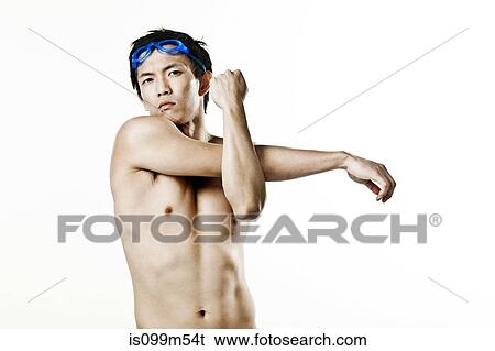 Stock Photograph - Swimmer stretching arm, portrait. Fotosearch
