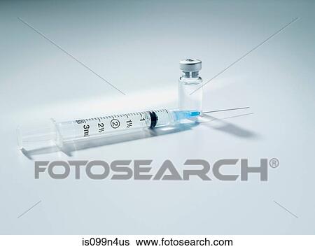 Stock Photograph - Syringe and vial, studio shot. Fotosearch