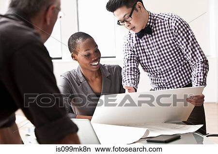 Picture - Three business people in meeting. Fotosearch