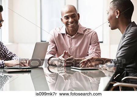 Three business people in meeting View Large Photo Image Stock Photography - Three business people in meeting. Fotosearch