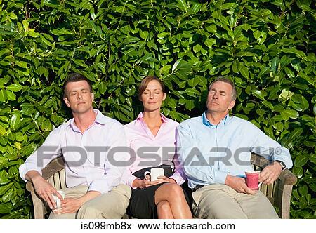 Three businesspeople sitting on bench, asleep View Large Photo Image Stock Photo - Three businesspeople sitting on bench, asleep. Fotosearch