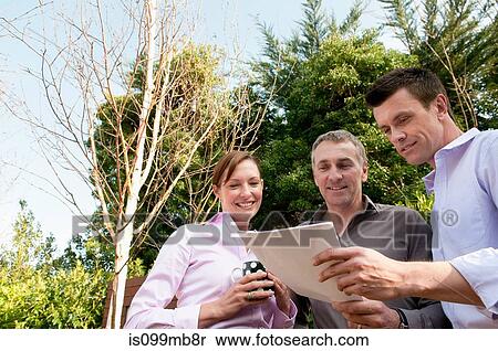 Stock Photography - Three businesspeople with document. Fotosearch
