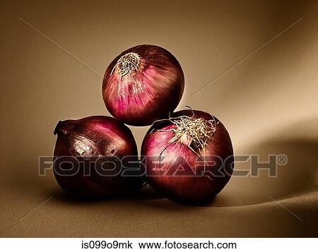 Stock Image - Three red onions. Fotosearch