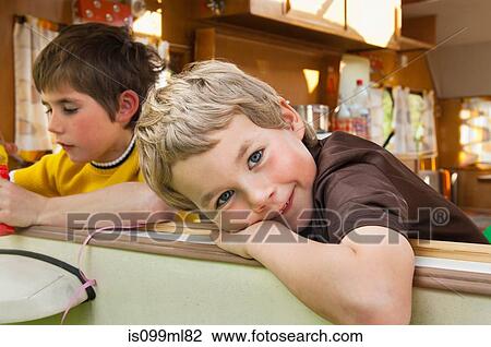 Two boys leaning out of caravan window, portrait View Large Photo Image Stock Image - Two boys leaning out of caravan window, portrait. Fotosearch