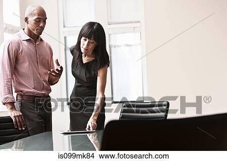 Two business colleagues using digital tablet View Large Photo Image Picture - Two business colleagues using digital tablet. Fotosearch