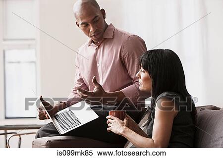 Two business colleagues using laptop View Large Photo Image Stock Photography - Two business colleagues using laptop. Fotosearch