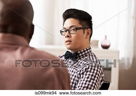 Two businessmen, one wearing bow tie View Large Photo Image Picture - Two businessmen, one wearing bow tie. Fotosearch