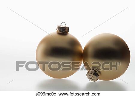 Two gold baubles View Large Photo Image Stock Image - Two gold baubles. Fotosearch