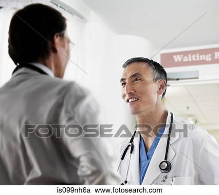 Two male doctors in discussion View Large Photo Image Stock Image - Two male doctors in discussion. Fotosearch