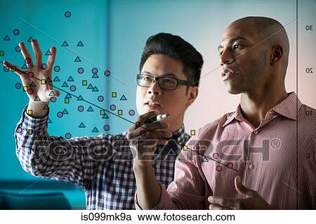 Two people looking at diagram on window View Large Photo Image Stock Image - Two people looking at diagram on window. Fotosearch