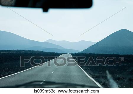 Stock Image - View from car on road through Montanas del Fuego, Lanzarote. Fotosearch