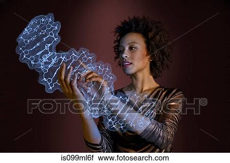 Stock Image - Woman interacting with holographic genome. Fotosearch