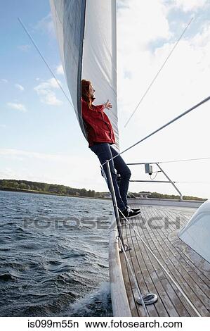 Woman leaning against sail on yacht View Large Photo Image Picture - Woman leaning against sail on yacht. Fotosearch