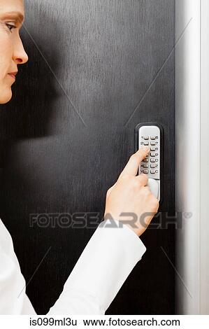 Woman pressing door keypad View Large Photo Image Stock Photograph - Woman pressing door keypad. Fotosearch