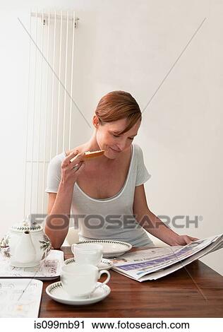Woman reading newspaper View Large Photo Image Stock Image - Woman reading newspaper. Fotosearch