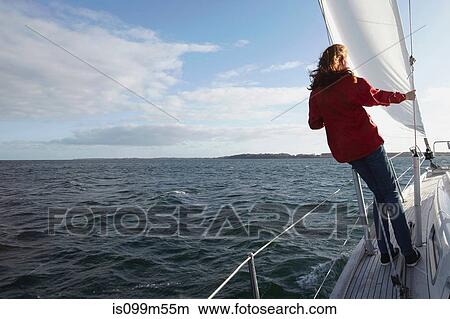 Picture - Woman sailing on yacht, rear view. Fotosearch