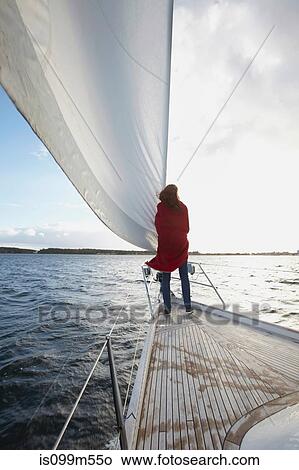 Woman standing by sail on yacht View Large Photo Image Picture - Woman standing by sail on yacht. Fotosearch