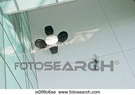 Woman walking across floor in office block View Large Photo Image Stock Image - Woman walking across floor in office block. Fotosearch