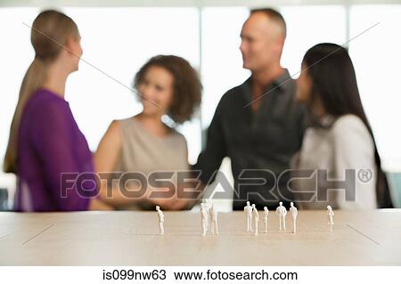 Young architect sitting at desk with model figures View Large Photo Image Stock Image - Young architect sitting at desk with model figures. Fotosearch