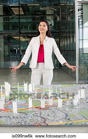 Young architect standing in front of model View Large Photo Image Stock Image - Young architect standing in front of model. Fotosearch