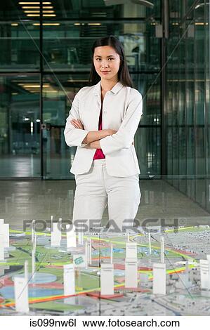 Young architect standing in front of model View Large Photo Image Stock Image - Young architect standing in front of model. Fotosearch