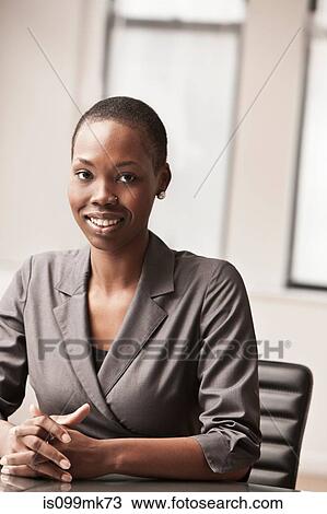 Young businesswoman at desk, portrait View Large Photo Image Stock Image - Young businesswoman at desk, portrait. Fotosearch