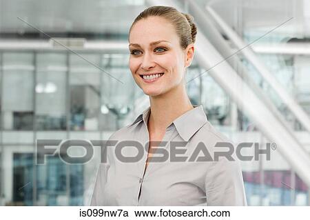 Young businesswoman in office, smiling View Large Photo Image Stock Image - Young businesswoman in office, smiling. Fotosearch