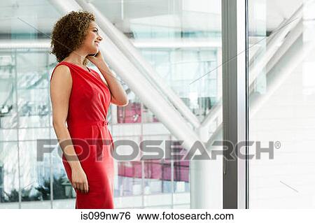 Young businesswoman in office using cellphone View Large Photo Image Stock Photograph - Young businesswoman in office using cellphone. Fotosearch