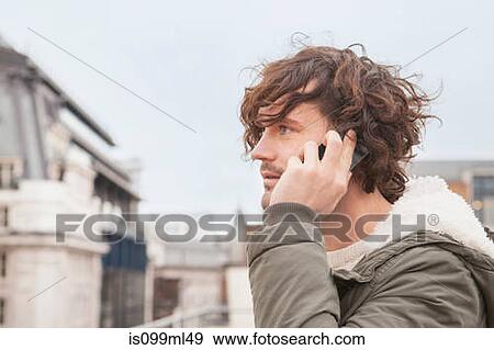 Young man on cell phone View Large Photo Image Stock Photo - Young man on cell phone. Fotosearch