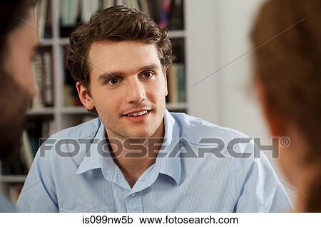 Young man smiling in gallery View Large Photo Image Stock Image - Young man smiling in gallery. Fotosearch