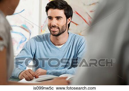 Stock Image - Young man smiling in gallery. Fotosearch