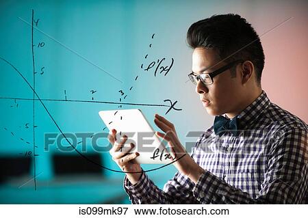 Young man using digital tablet with diagram on window View Large Photo Image Stock Photo - Young man using digital tablet with diagram on window. Fotosearch