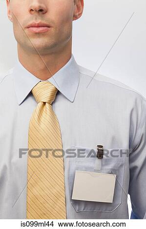 Young man wearing tie and name badge View Large Photo Image Picture - Young man wearing tie and name badge. Fotosearch