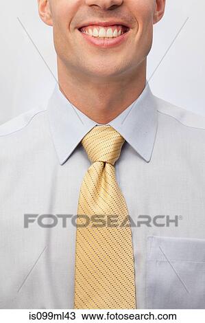 Stock Image - Young man wearing tie, close up portrait. Fotosearch