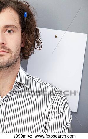 Stock Photo - Young man with blank piece of paper, portrait. Fotosearch