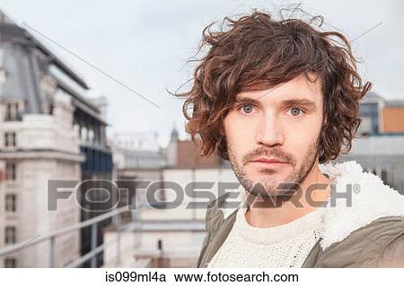 Young man with brown curly hair, close up portrait View Large Photo Image Stock Image - Young man with brown curly hair, close up portrait. Fotosearch