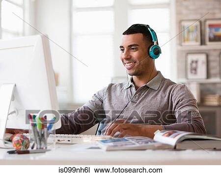 Young man working on computer in office View Large Photo Image Stock Image - Young man working on computer in office. Fotosearch
