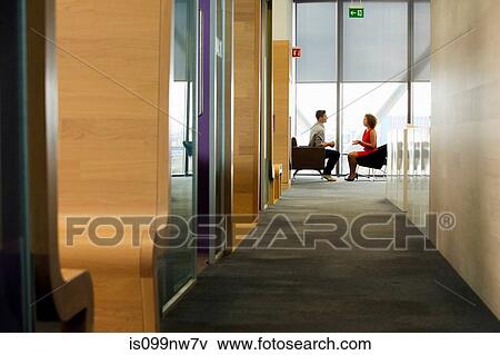 Young woman and man in meeting in office View Large Photo Image Stock Photo - Young woman and man in meeting in office. Fotosearch