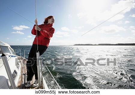Young woman holding onto rope on yacht View Large Photo Image Stock Image - Young woman holding onto rope on yacht. Fotosearch