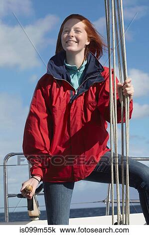 Young woman holding onto rope on yacht View Large Photo Image Stock Image - Young woman holding onto rope on yacht. Fotosearch